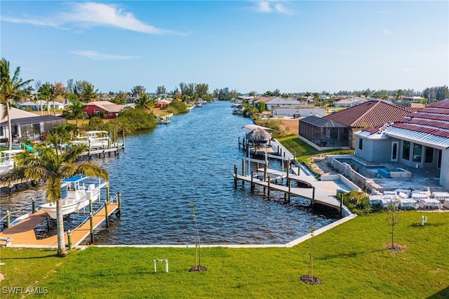 dock area featuring a water view and a lawn