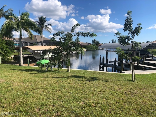 view of dock featuring a water view and a lawn