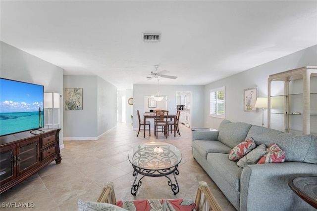 living room featuring light tile patterned floors and ceiling fan