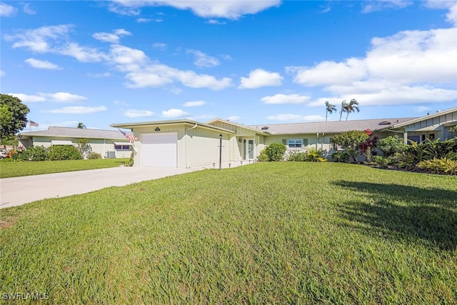 single story home featuring a garage and a front lawn