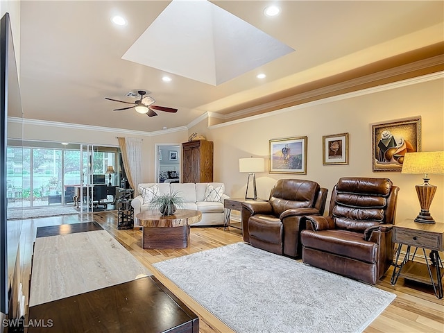 living room with ceiling fan, crown molding, and light hardwood / wood-style floors