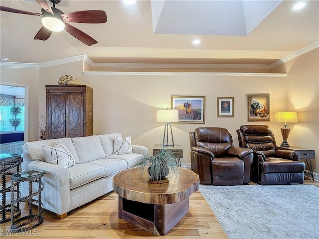 living room with light hardwood / wood-style flooring, ceiling fan, and crown molding