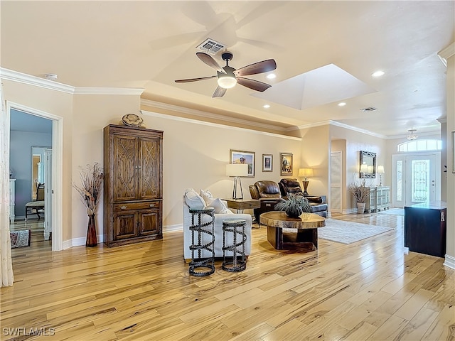 living room with light hardwood / wood-style flooring, ceiling fan, and crown molding