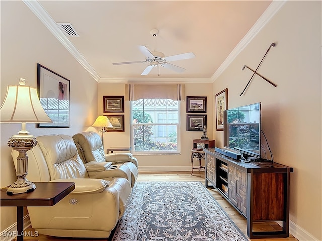 living room featuring ornamental molding, ceiling fan, and light hardwood / wood-style flooring