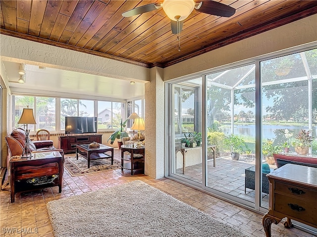 sunroom with ceiling fan and wooden ceiling