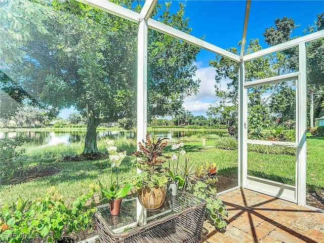 unfurnished sunroom with a water view