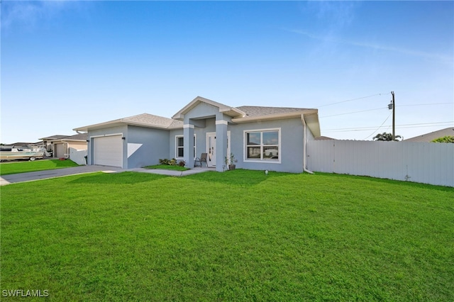 view of front of house featuring a front lawn and a garage