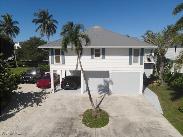 view of front of house featuring a carport, a garage, and a balcony