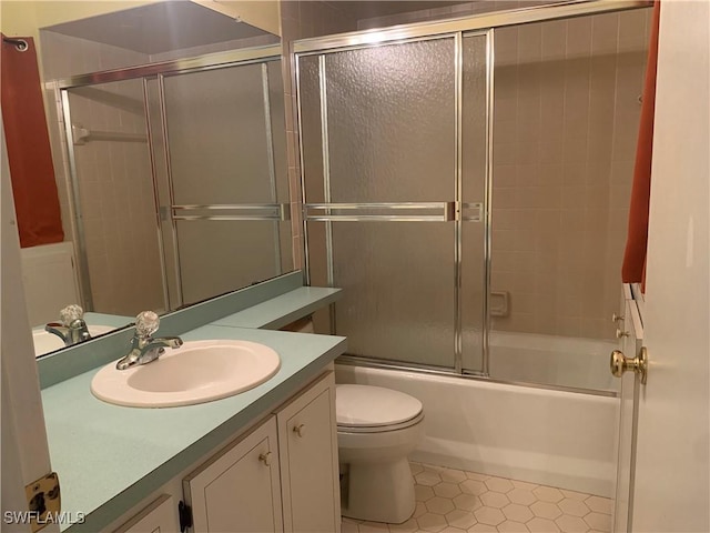 full bathroom featuring tile patterned flooring, vanity, enclosed tub / shower combo, and toilet