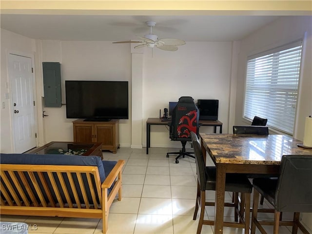 interior space with light tile patterned floors, electric panel, and ceiling fan