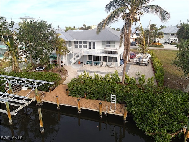 rear view of house with a patio area and a water view