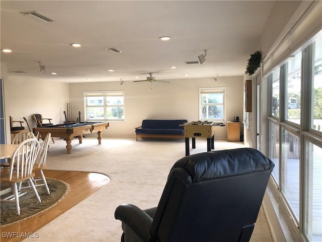 rec room with a wealth of natural light, ceiling fan, light hardwood / wood-style floors, and billiards