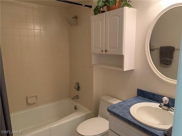 full bathroom featuring vanity, tiled shower / bath combo, and toilet