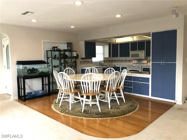 dining area with dark hardwood / wood-style flooring and sink