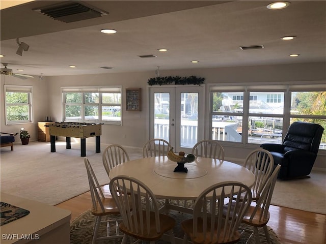 carpeted dining room featuring french doors and ceiling fan