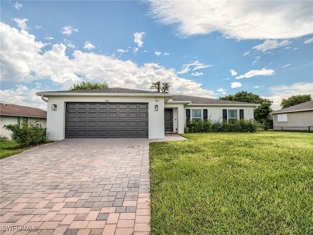 ranch-style house with a front yard and a garage