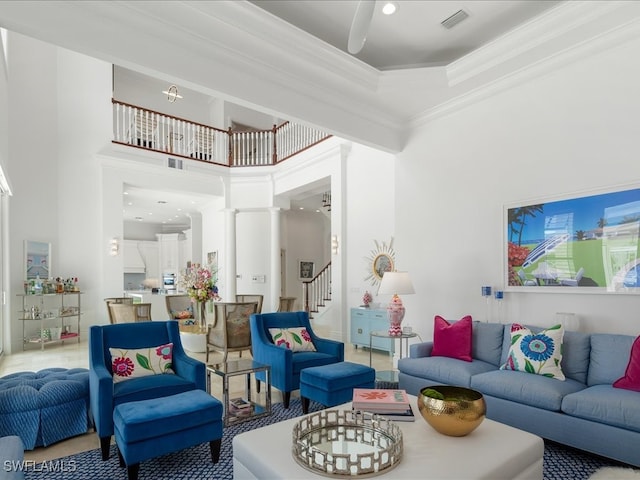 living room with ornamental molding, a high ceiling, and decorative columns