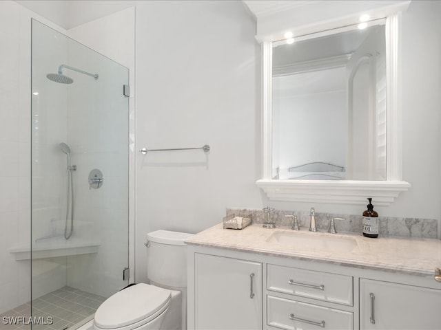 bathroom with toilet, a shower with shower door, and vanity