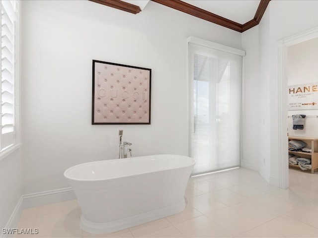 bathroom with ornamental molding, a tub to relax in, and tile patterned floors