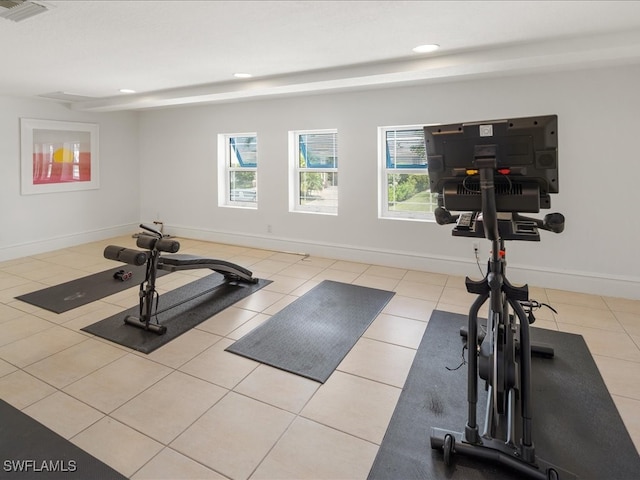 exercise room with light tile patterned floors