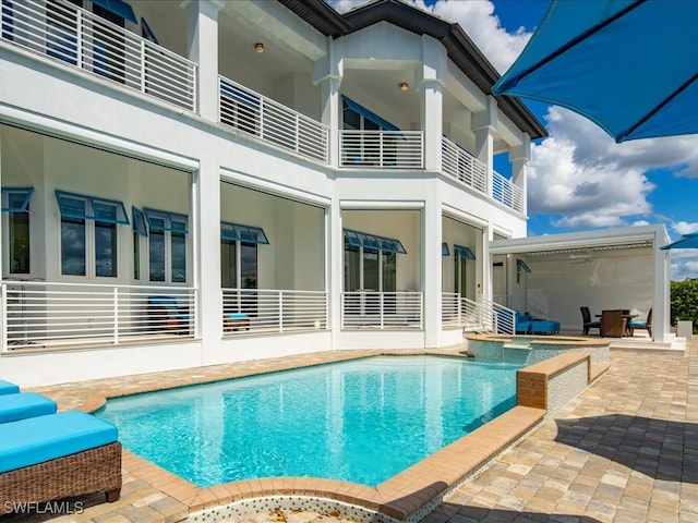 back of property featuring a balcony and a patio