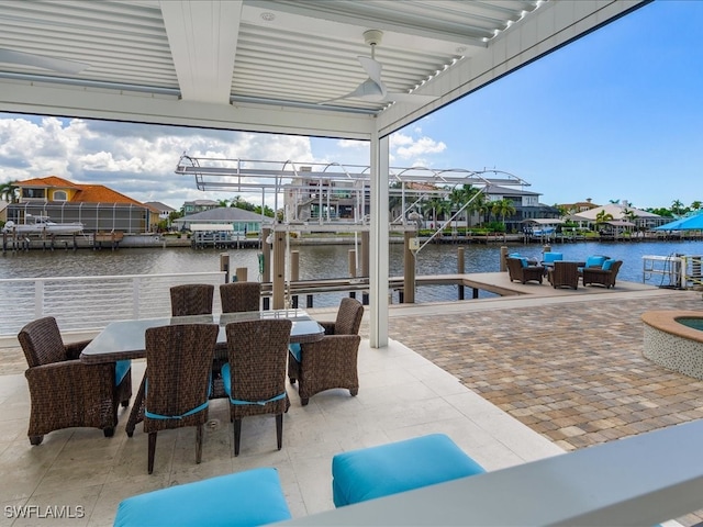 view of patio featuring a dock and a water view