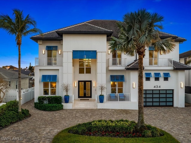 view of front of property with a balcony and a garage