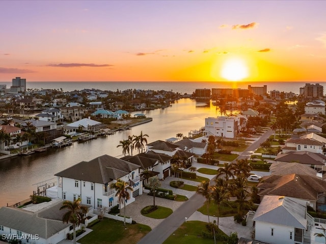 aerial view at dusk with a water view