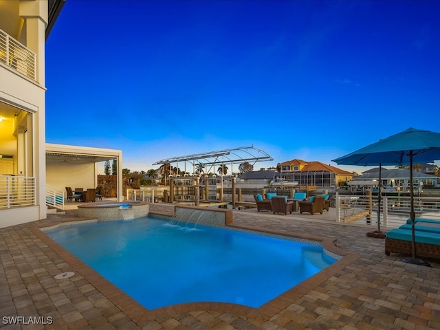 view of pool featuring an in ground hot tub, a patio, and pool water feature