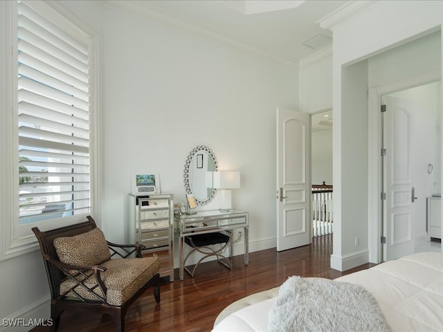 bedroom with ornamental molding and dark hardwood / wood-style flooring