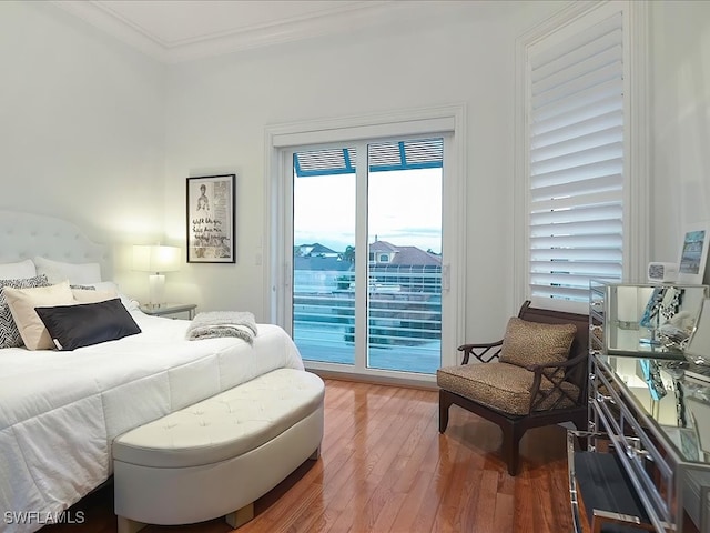 bedroom featuring crown molding, access to outside, and hardwood / wood-style floors