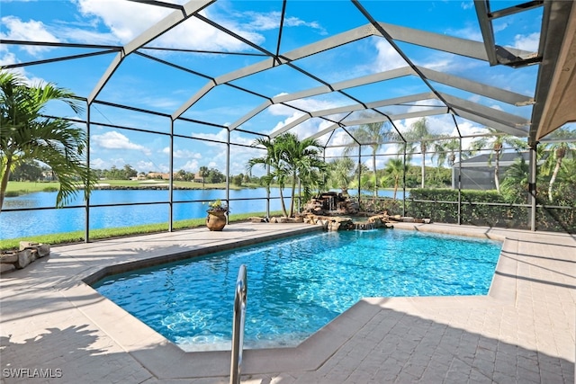 view of swimming pool featuring pool water feature, a water view, a patio area, and glass enclosure