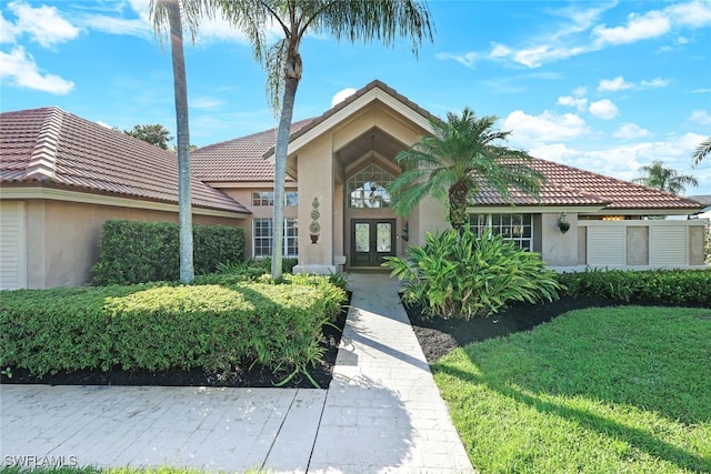 view of front of home with french doors and a front yard