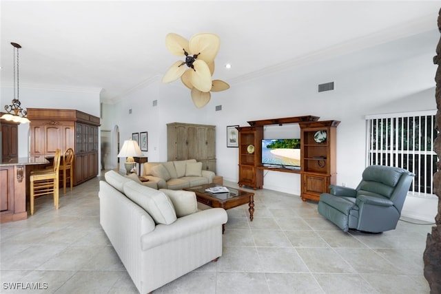 living room featuring ceiling fan, light tile patterned flooring, a towering ceiling, and ornamental molding