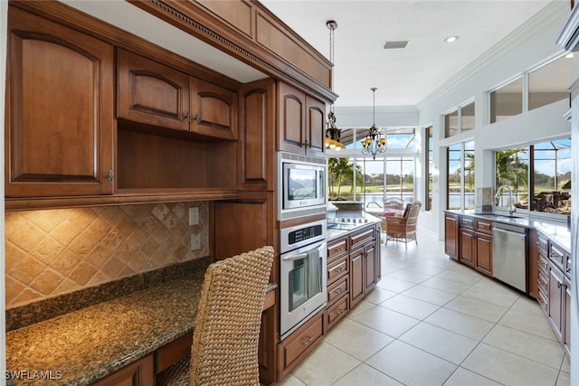 kitchen featuring decorative backsplash, dark stone countertops, stainless steel appliances, an inviting chandelier, and decorative light fixtures