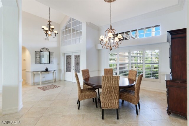 dining area featuring light tile patterned flooring, a chandelier, and high vaulted ceiling