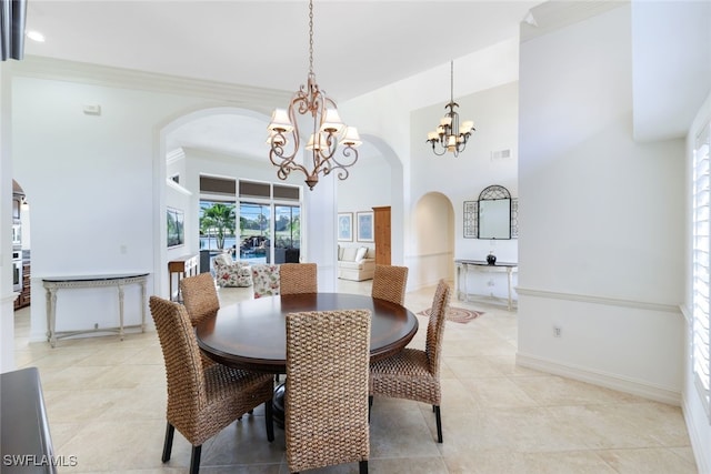 tiled dining area featuring a high ceiling and a notable chandelier