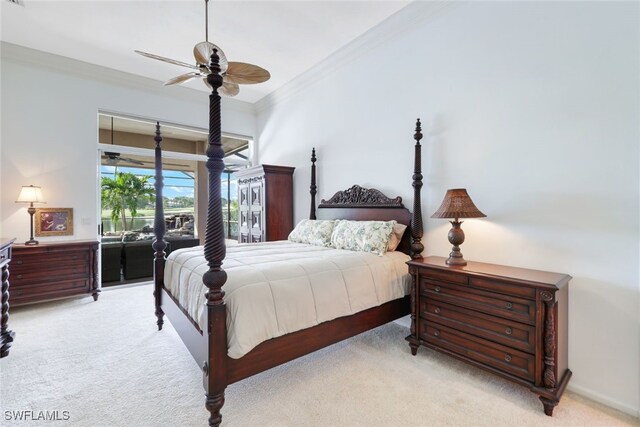 carpeted bedroom featuring ceiling fan and crown molding