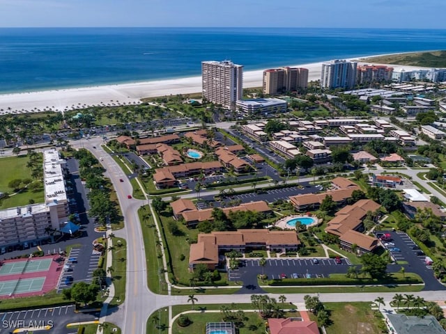 drone / aerial view featuring a water view and a beach view