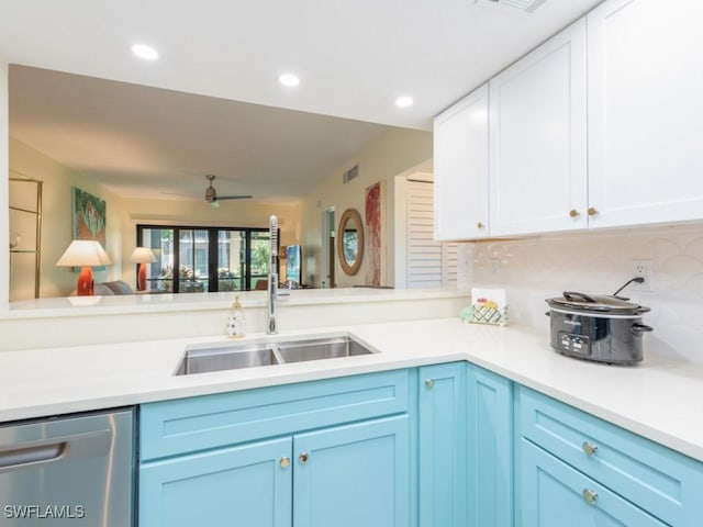 kitchen featuring kitchen peninsula, stainless steel dishwasher, ceiling fan, sink, and white cabinetry