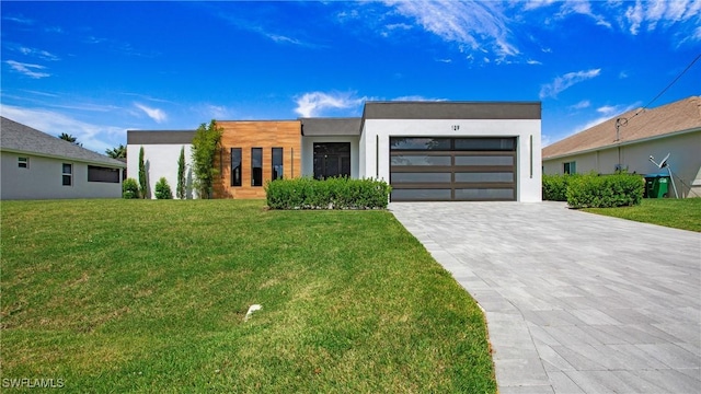 contemporary home with a front lawn and a garage