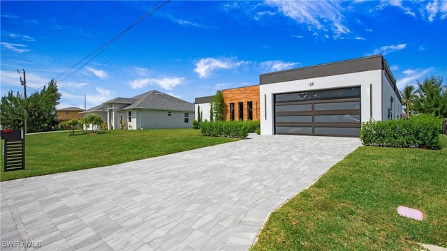 modern home featuring a front yard and a garage