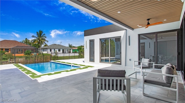 view of pool featuring ceiling fan and a patio