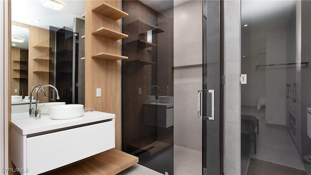 bathroom featuring an enclosed shower and vanity