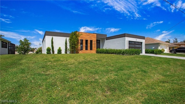 modern home featuring a garage and a front yard