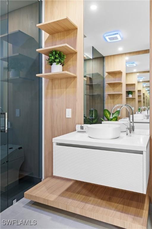 bathroom with an enclosed shower and vanity