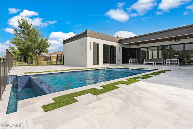 view of pool featuring ceiling fan, an outdoor hangout area, and a patio