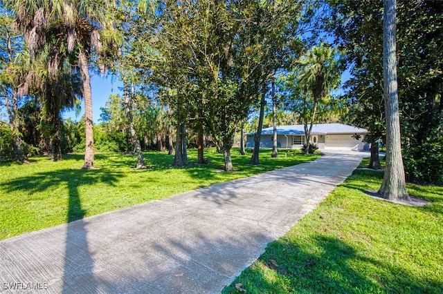 view of front of property with a garage and a front yard