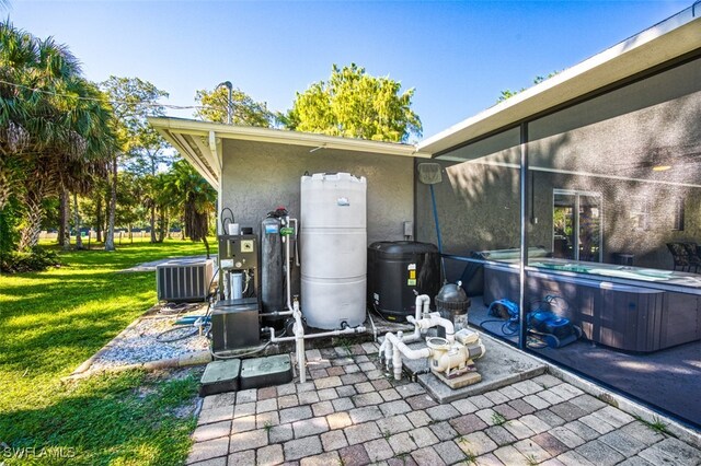 view of patio featuring central air condition unit and a hot tub