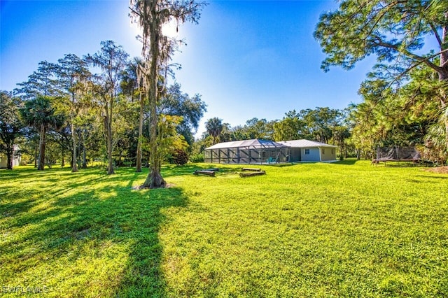 view of yard featuring glass enclosure